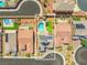 Aerial view of backyard oasis featuring a pool, hot tub, putting green, solar panels, and covered patio at 8925 Kenzie Cove St, Las Vegas, NV 89131