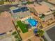Overhead view of a home with solar panels, a pool, gazebo, and lush green space in a neatly landscaped backyard at 8925 Kenzie Cove St, Las Vegas, NV 89131