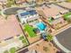 Expansive aerial view of a property showcasing a pool, gazebo, lush green lawn, and solar panels on the roof at 8925 Kenzie Cove St, Las Vegas, NV 89131