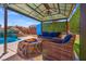 Inviting backyard patio with a fire pit, comfortable seating, and covered gazebo area, perfect for outdoor entertaining at 8925 Kenzie Cove St, Las Vegas, NV 89131