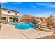 Captivating backyard pool featuring a rock waterfall and steps, perfect for relaxation and outdoor enjoyment at 8925 Kenzie Cove St, Las Vegas, NV 89131