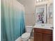 Well-maintained bathroom with shower and curtain adjacent to the sink and toilet at 8925 Kenzie Cove St, Las Vegas, NV 89131