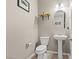 Elegant powder room with pedestal sink, decorative mirror, tiled floor, and contemporary fixtures at 8925 Kenzie Cove St, Las Vegas, NV 89131