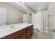 Bathroom featuring tile floors, large vanity and shower with white tile at 8925 Kenzie Cove St, Las Vegas, NV 89131