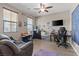 Bright bedroom featuring hardwood floors, two windows, and desk area; perfect for a home office at 8925 Kenzie Cove St, Las Vegas, NV 89131