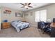 Comfortable bedroom featuring a ceiling fan, carpet and a window for natural light at 8925 Kenzie Cove St, Las Vegas, NV 89131