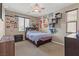 Comfortable bedroom featuring a ceiling fan, window, dresser, and fun décor throughout at 8925 Kenzie Cove St, Las Vegas, NV 89131