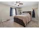 Neutral bedroom with built-in storage in bed frame, ceiling fan, and window with light-blocking curtains at 8925 Kenzie Cove St, Las Vegas, NV 89131