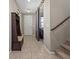 Welcoming entryway with stylish bench and hooks, sliding barn door, and staircase leading upstairs at 8925 Kenzie Cove St, Las Vegas, NV 89131