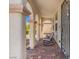 Inviting front porch with a tile floor, decorative columns, and comfortable seating for relaxation at 8925 Kenzie Cove St, Las Vegas, NV 89131