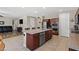 Bright kitchen with stainless steel appliances, center island and breakfast bar, and wood cabinets at 8925 Kenzie Cove St, Las Vegas, NV 89131