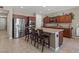 Well-equipped kitchen with granite countertops, dark cabinets, stainless steel appliances, and a central island at 8925 Kenzie Cove St, Las Vegas, NV 89131