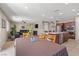 Open-concept kitchen and dining area featuring dark cabinetry, stainless appliances and living area in the background at 8925 Kenzie Cove St, Las Vegas, NV 89131