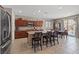 Spacious kitchen featuring granite countertops, dark wood cabinets, stainless steel appliances, and island seating at 8925 Kenzie Cove St, Las Vegas, NV 89131