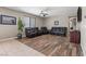 Relaxing living room with wood floors, a ceiling fan, and comfortable leather seating for entertainment at 8925 Kenzie Cove St, Las Vegas, NV 89131