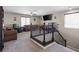 Cozy loft area at the top of stairs with carpeting and comfortable seating for relaxing and entertaining at 8925 Kenzie Cove St, Las Vegas, NV 89131
