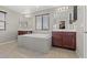 Bright and airy main bathroom with dual vanities and a large soaking tub under a window at 8925 Kenzie Cove St, Las Vegas, NV 89131