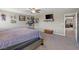 Comfortable main bedroom with cozy décor featuring a ceiling fan, mounted TV, and plenty of artwork at 8925 Kenzie Cove St, Las Vegas, NV 89131