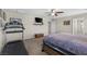 Cozy main bedroom featuring a ceiling fan, mounted television, and workout area with treadmill at 8925 Kenzie Cove St, Las Vegas, NV 89131