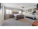 Spacious main bedroom featuring a ceiling fan, large window and adjacent workout area with treadmill at 8925 Kenzie Cove St, Las Vegas, NV 89131