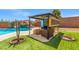 Backyard featuring a pool with an outdoor living area and beautiful landscaping at 8925 Kenzie Cove St, Las Vegas, NV 89131