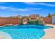 Backyard featuring a refreshing swimming pool and hot tub with rock waterfall at 8925 Kenzie Cove St, Las Vegas, NV 89131