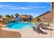 Backyard featuring a refreshing swimming pool and hot tub with lounge chairs at 8925 Kenzie Cove St, Las Vegas, NV 89131