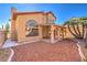 This home's backyard includes a covered patio and minimalist desert-style landscaping at 8932 Beach Front Dr, Las Vegas, NV 89117