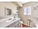 Bathroom featuring a single sink with gray cabinets and a shower over tub at 8932 Beach Front Dr, Las Vegas, NV 89117