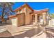 Charming stucco home with a tile roof, arched entryway, and a spacious two-car garage at 8932 Beach Front Dr, Las Vegas, NV 89117