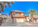 Two-story stucco home with tile roof, an attached garage, and a well-maintained front yard at 8932 Beach Front Dr, Las Vegas, NV 89117