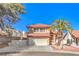 Charming two-story home featuring a well-manicured lawn, a two car garage, and a decorative palm tree at 8932 Beach Front Dr, Las Vegas, NV 89117