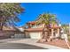 Charming two-story home featuring a well-manicured front yard and a two-car garage at 8932 Beach Front Dr, Las Vegas, NV 89117