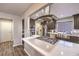 Modern kitchen features a stainless steel range hood, stainless appliances, and a kitchen island with cooktop at 8932 Beach Front Dr, Las Vegas, NV 89117