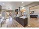 Open kitchen with stainless steel appliances, kitchen island, and an adjoining living room at 8932 Beach Front Dr, Las Vegas, NV 89117