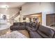 Spacious open-concept living room featuring a sectional couch and wood-look floors at 8932 Beach Front Dr, Las Vegas, NV 89117