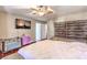 Bright main bedroom featuring wood floors, ceiling fan, and dresser, with ample natural light at 8932 Beach Front Dr, Las Vegas, NV 89117