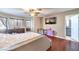Bright main bedroom boasts wood floors, ceiling fan, and dresser, with ample natural light at 8932 Beach Front Dr, Las Vegas, NV 89117