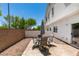 Secluded backyard with desert landscaping, patio seating, and access to the house at 9362 Straw Hays St # 103, Las Vegas, NV 89178