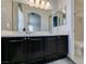 Clean bathroom with dual sinks, dark cabinetry, and a shower-tub combo at 9362 Straw Hays St # 103, Las Vegas, NV 89178