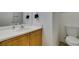Clean bathroom with a toilet, sink, and large mirror above the countertop at 9362 Straw Hays St # 103, Las Vegas, NV 89178