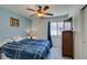 Comfortable bedroom with blue and white décor, a window, and modern fan at 9362 Straw Hays St # 103, Las Vegas, NV 89178