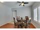 Cozy dining area with a modern ceiling fan and window with plantation shutters at 9362 Straw Hays St # 103, Las Vegas, NV 89178
