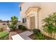The front door and entrance feature desert landscaping and ample foliage at 9362 Straw Hays St # 103, Las Vegas, NV 89178