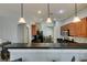 Charming kitchen featuring wood cabinets, breakfast bar, and stainless steel appliances at 9362 Straw Hays St # 103, Las Vegas, NV 89178