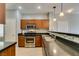 Well-equipped kitchen featuring stainless steel appliances, wood cabinets and a breakfast bar at 9362 Straw Hays St # 103, Las Vegas, NV 89178