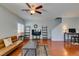 Living room with hardwood floors, a ceiling fan, recessed lights, a sofa, and access to the second story at 9362 Straw Hays St # 103, Las Vegas, NV 89178