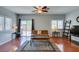 Living room with a ceiling fan, recessed lighting, hardwood floors, and a sliding glass door to the patio at 9362 Straw Hays St # 103, Las Vegas, NV 89178