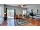 Living room with hardwood floors, a ceiling fan, recessed lights, and a door leading to the patio at 9362 Straw Hays St # 103, Las Vegas, NV 89178