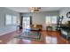 Inviting living room with wood floors, ceiling fan, and sliding glass door to the exterior at 9362 Straw Hays St # 103, Las Vegas, NV 89178